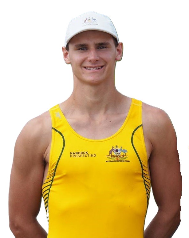 Portrait of a young man in a yellow team jersey and white cap, smiling at the camera.