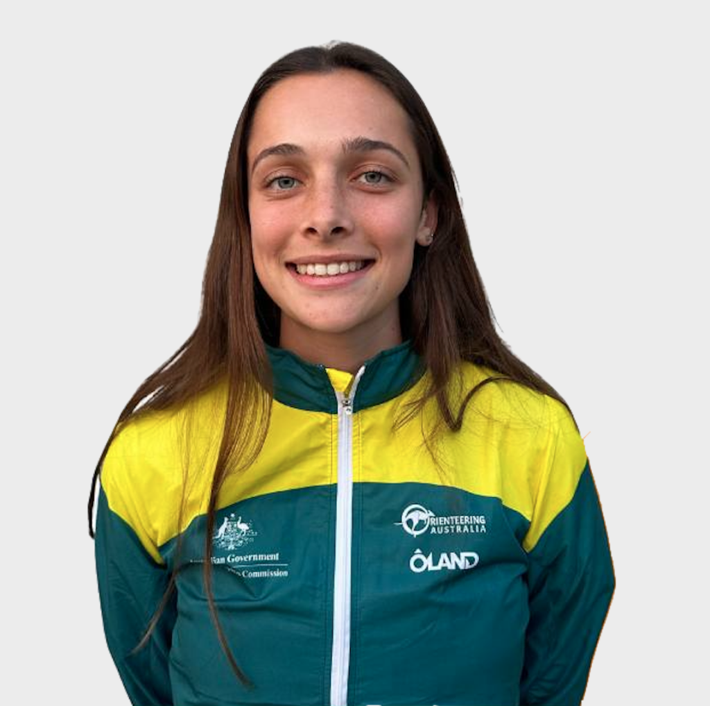 Portrait of a smiling young woman with long brown hair, wearing a teal and yellow jacket with Orienteering Australia logo.