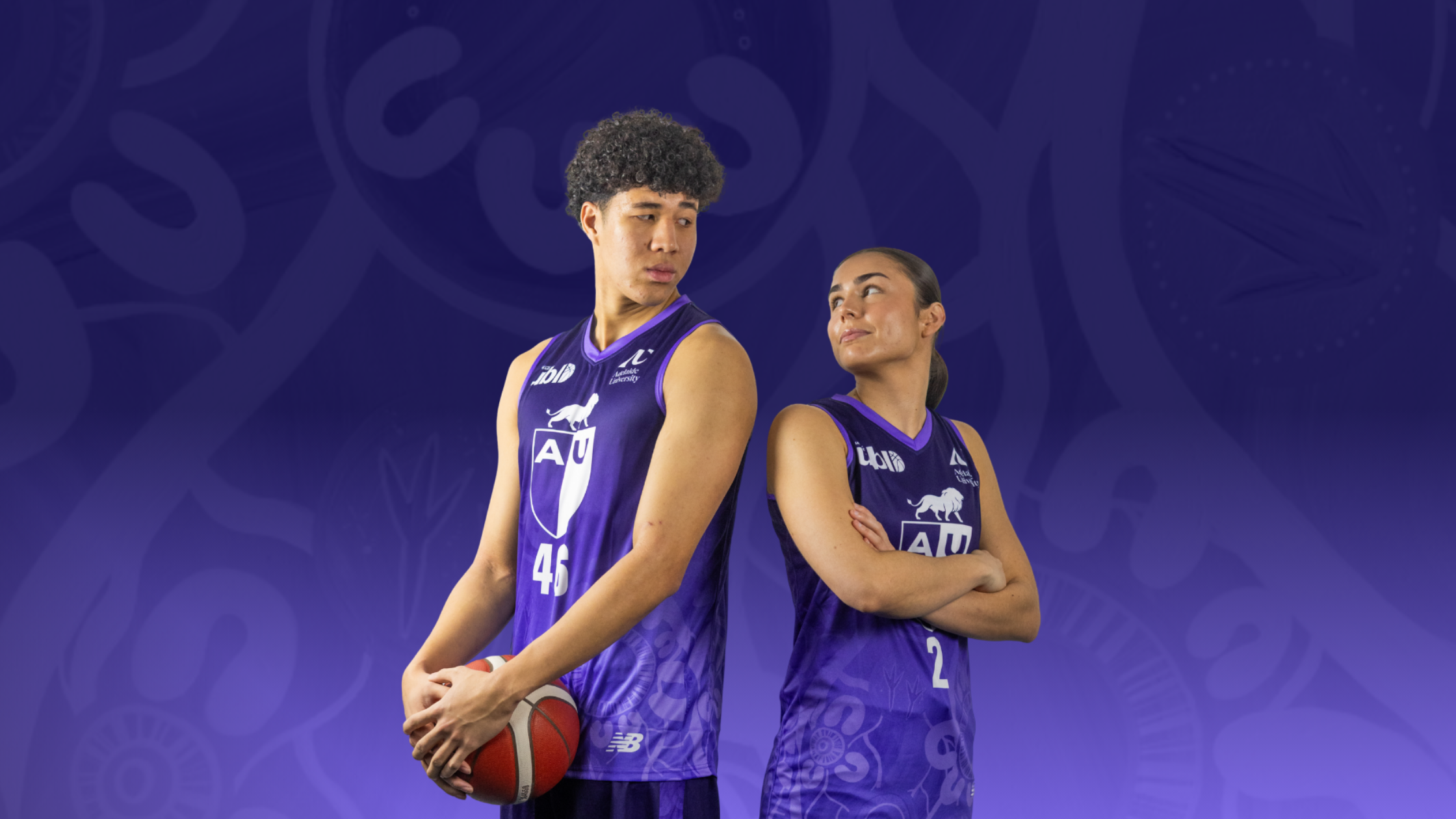 Two female basketball players in purple uniforms stand back-to-back, one holding a basketball, against a purple gradient background with faint logos.